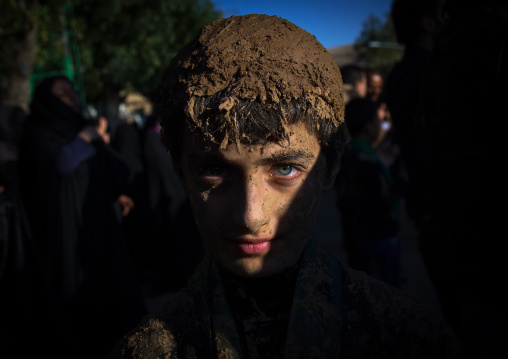 Iranian Shiite Muslim Boy With Green Eyes Covered In Mud During Ashura Day, Kurdistan Province, Bijar, Iran