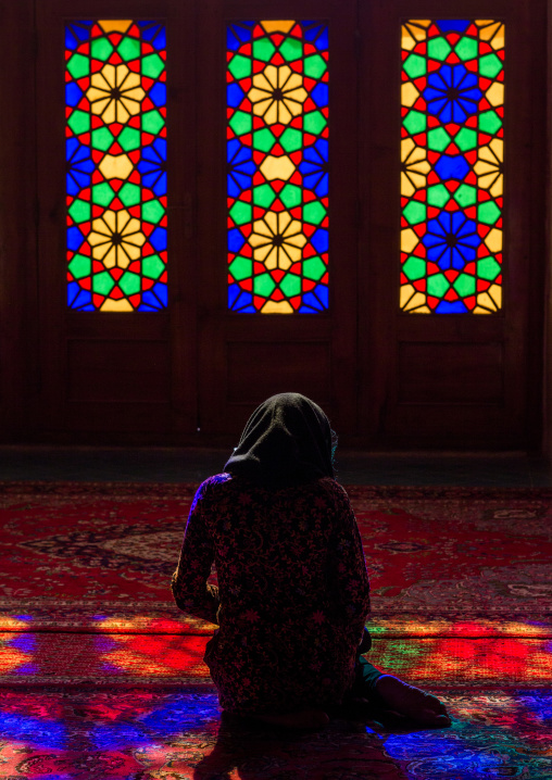 Iranian Woman Praying In The Nasir Ol Molk Mosque With Its Beautiful Coloured Glass Windows, Fars Province, Shiraz, Iran