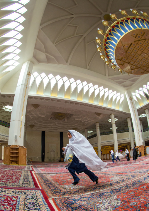 Muslim Girl Running In The Shah-e-cheragh Mausoleum, Fars Province, Shiraz, Iran
