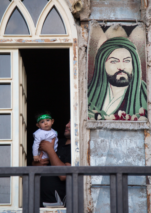 Iranian Shiite Muslim Father And His Son Dressed For Muharram In Front Of An Imam Hussein Portrait, Isfahan Province, Kashan, Iran