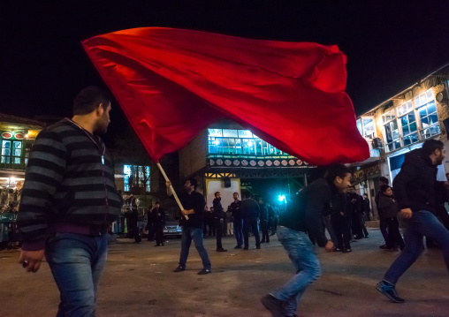 Iranian Shiite Muslims Man Parading With Red Flag During Ashura, The Day Of The Death Of Imam Hussein, Golestan Province, Gorgan, Iran