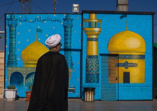 Mullah Passing In Front Of A Painting Depicting A Mosque, Central County, Qom, Iran