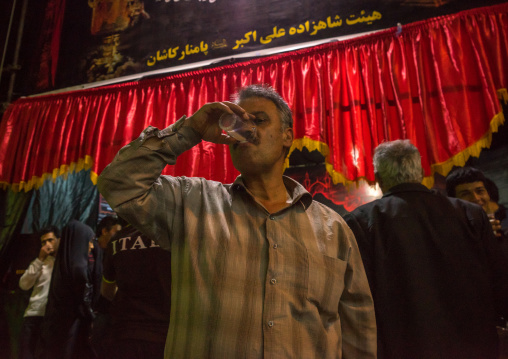 Iranian Shiite Muslim People Drinking Nazri Hot Milk Distributed Freely During Muharram, Isfahan Province, Kashan, Iran