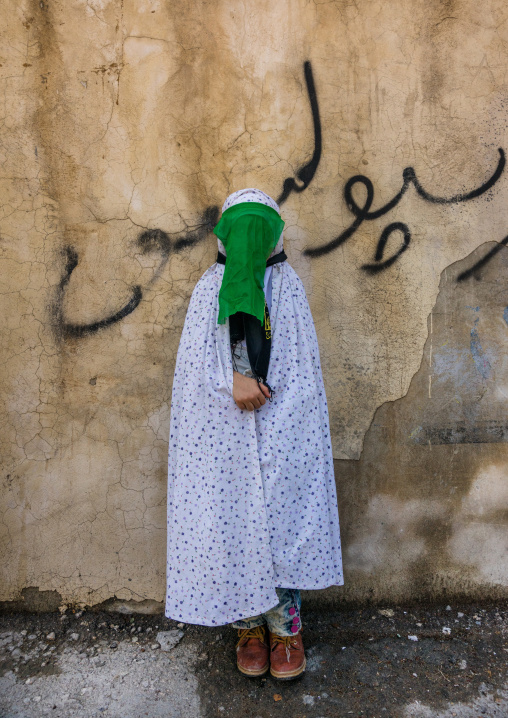 Iranian Shiite Muslim Woman Mourning Imam Hussein On The Day Of Tasua With Her Face Covered By A Green Veil, Lorestan Province, Khorramabad, Iran