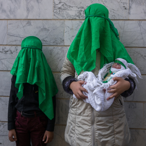 Shiite Muslim Woman With Her Son And A Baby Doll Mourning Imam Hussein On The Day Of Tasua, Lorestan Province, Khorramabad, Iran