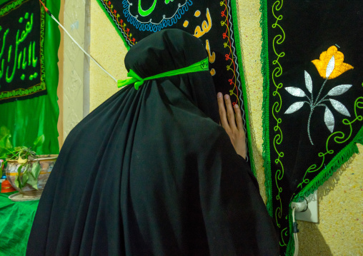 Iranian Woman Kissing A Shiite Banner For Chehel Menbari Festival On Tasu'a Day To Commemorate The Anniversary Of Imam Hussein, Lorestan Province, Khorramabad, Iran