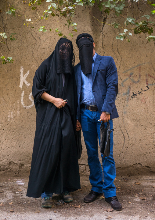 Iranian Shiite Muslim Couple Mourning Imam Hussein On The Day Of Tasua With Their Faces Covered By A Veil, Lorestan Province, Khorramabad, Iran