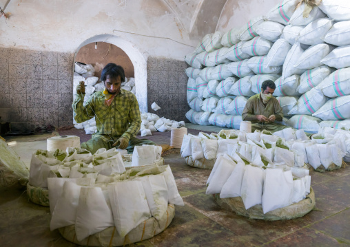 Men Packing Henna Bags In A Traditional Mill, Yazd Province, Yazd, Iran