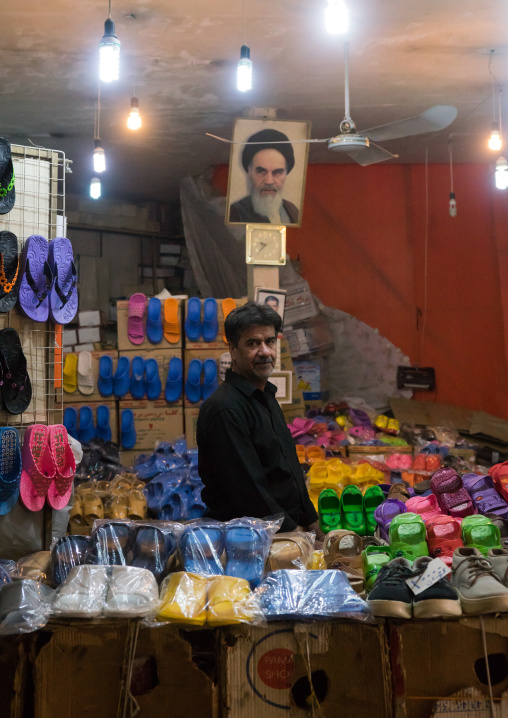 Shoes Seller In His Shop Decorated With Ayatollah Khomeini Picture, Fars Province, Shiraz, Iran