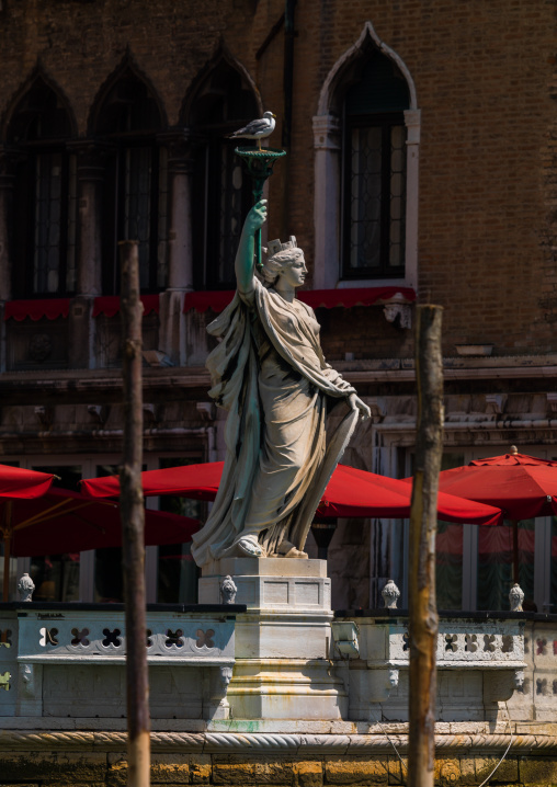 Statue of a lady with a torch on the grand canal, Veneto Region, Venice, Italy