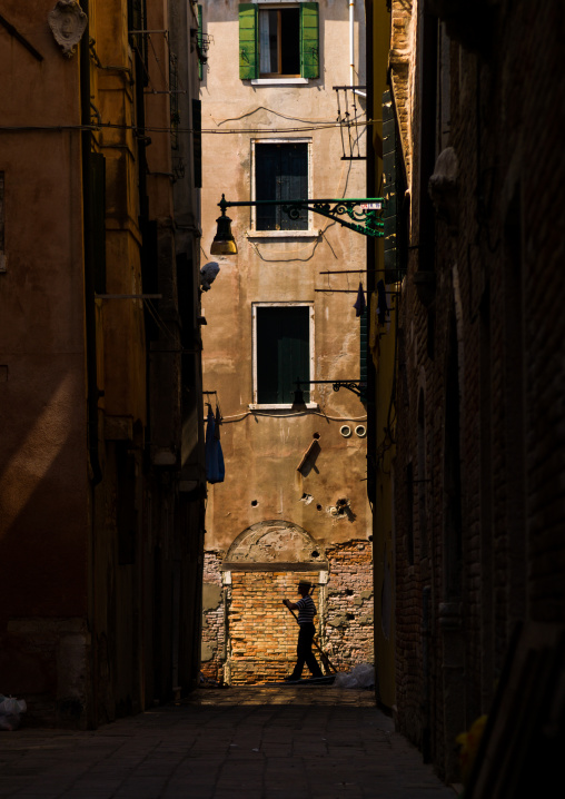 Gondola passing in front of venetian decayed facades, Veneto Region, Venice, Italy