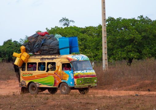 Colorful painted local taxi bus in the countryside, Savanes district, Waraniene, Ivory Coast