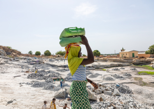 African women carrying stones in a granite quarry, Savanes district, Shienlow, Ivory Coast