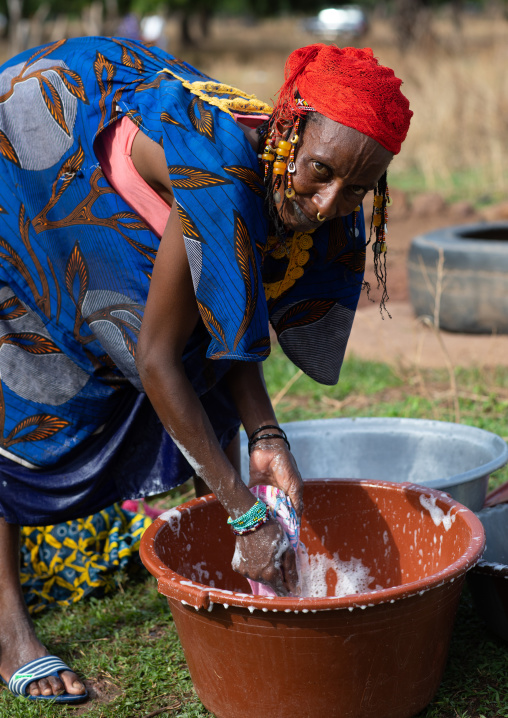 Peul tribe woman washing clothes in a bucket, Savanes district, Boundiali, Ivory Coast