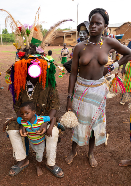 Young Senufo shirtless woman with the village chief during the Ngoro ceremony, Savanes district, Ndara, Ivory Coast