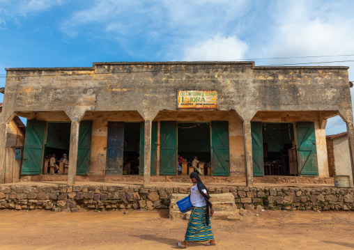 African woman passing in front of a coranic school, Tonkpi Region, Man, Ivory Coast