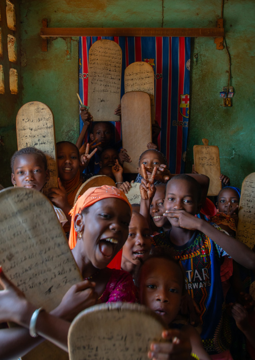 Children with wood boards for writing koran in a koranic school, Tonkpi Region, Man, Ivory Coast