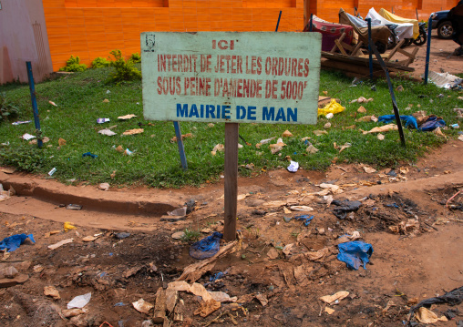 Garbage in front of a billboard to fight against pollution, Tonkpi Region, Man, Ivory Coast