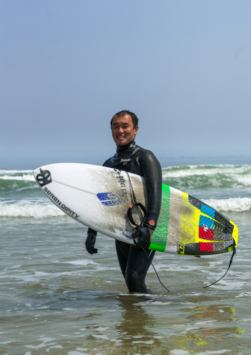 Japanese surfer in the contaminated area after the daiichi nuclear power plant irradiation, Fukushima prefecture, Tairatoyoma beach, Japan
