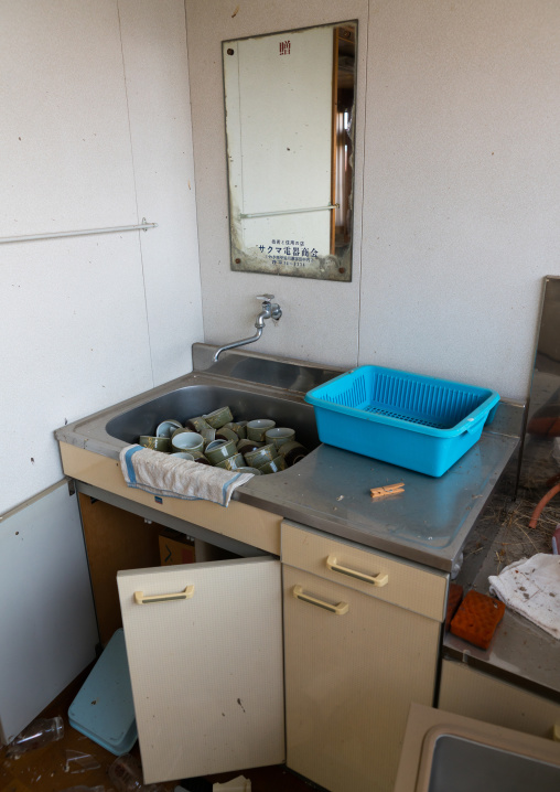 Kitchen in an abandoned house in the difficult-to-return zone after the daiichi nuclear power plant irradiation, Fukushima prefecture, Tomioka, Japan