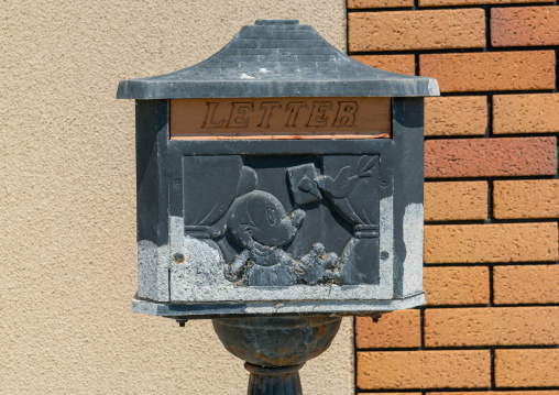 Letter box with mickey mouse of a house destroyed by the 2011 earthquake and tsunami five years after, Fukushima prefecture, Namie, Japan
