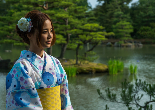 Chinese tourist woman wearing geisha kimonos in a traditional garden, Kansai region, Kyoto, Japan