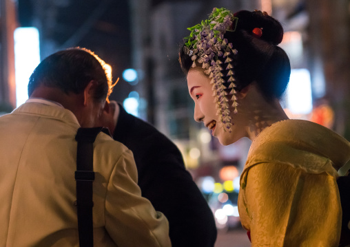 Geisha with business men in the streets of gion, Kansai region, Kyoto, Japan