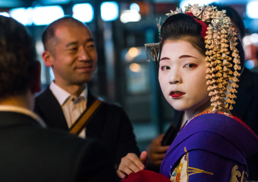 Geisha with businessmen in the streets of gion, Kansai region, Kyoto, Japan