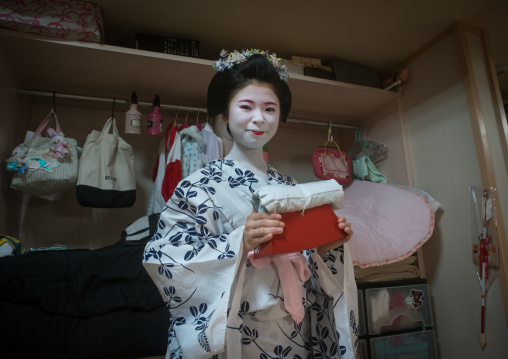 16 Years old maiko called chikasaya with the pillow shes uses to protect her hairstyle, Kansai region, Kyoto, Japan
