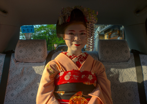 16 Years old maiko called chikasaya in a taxi, Kansai region, Kyoto, Japan