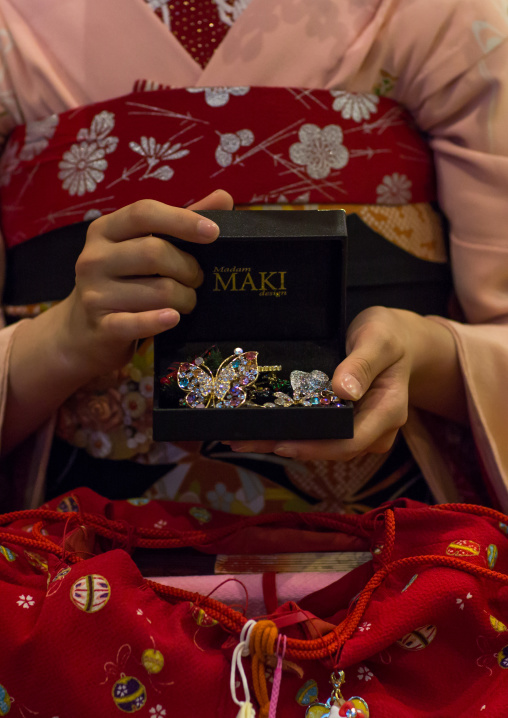 16 Years old maiko called chikasaya showing her brooches, Kansai region, Kyoto, Japan