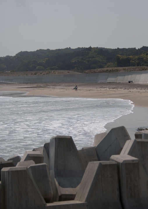 Japanese surfer in the contaminated area after the daiichi nuclear power plant irradiation, Fukushima prefecture, Tairatoyoma beach, Japan