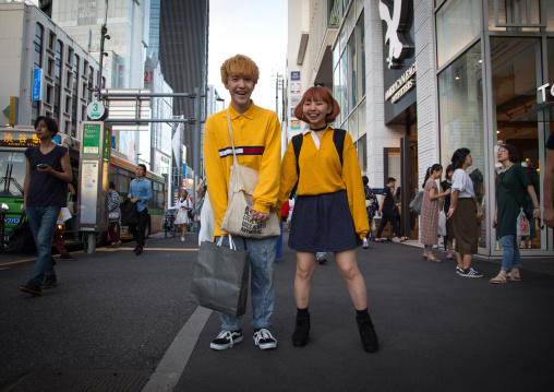 Young japanese woman and man shopping  in the street, Kanto region, Tokyo, Japan