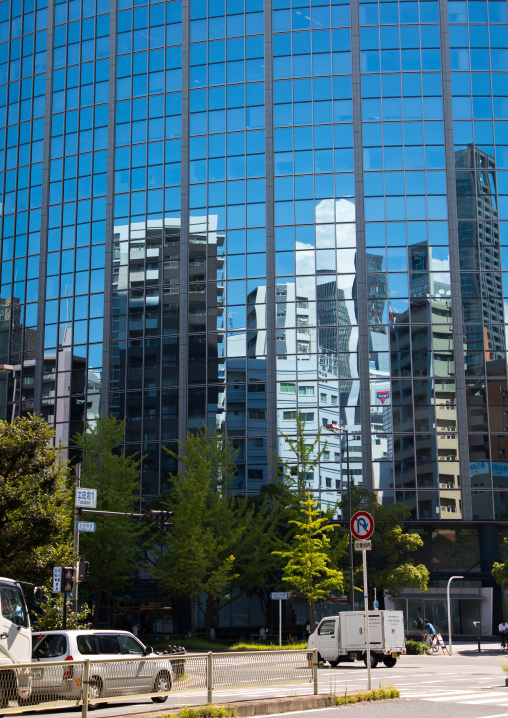 Glass building with reflections on the windows, Kansai region, Osaka, Japan
