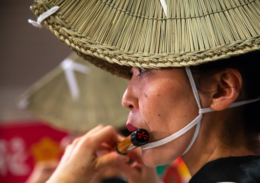 Japanese woman with straw hat during the Koenji Awaodori dance summer street festival, Kanto region, Tokyo, Japan