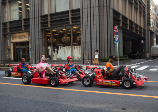 People driving karting cars dressed in super Mario, Kanto region, Tokyo, Japan