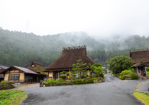 Thatched roofed houses in a traditional village in the fog, Kyoto Prefecture, Miyama, Japan