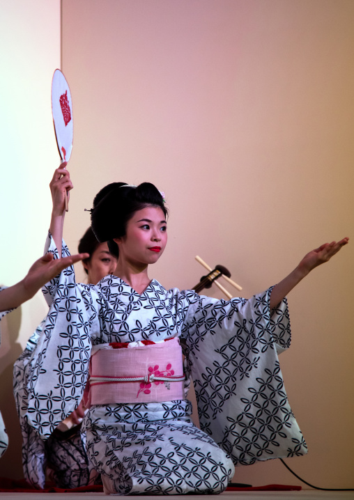 Maiko women dancing on stage during a show, Kansai region, Kyoto, Japan