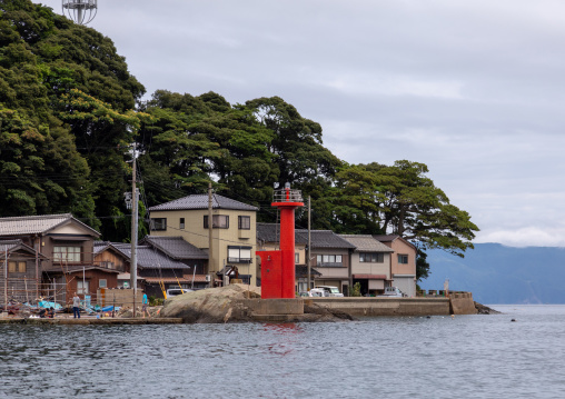 Red lighthouse in front of funaya fishermen houses, Kyoto prefecture, Ine, Japan