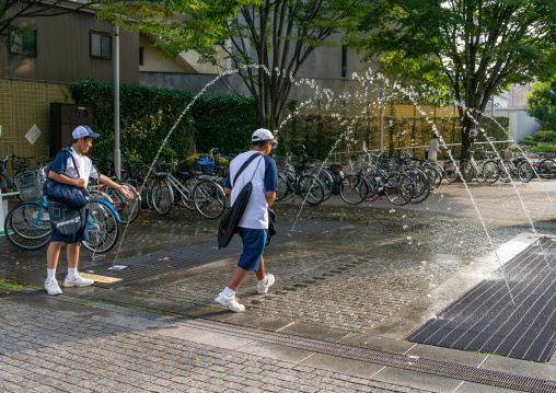 Japanese teenage boys playing with a fountain, Ishikawa Prefecture, Kanazawa, Japan
