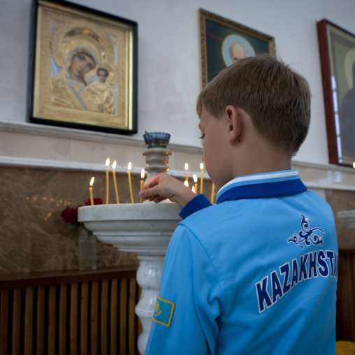 Boy Praying In A Russian Orthodox Church, Astana, Kazakhstan