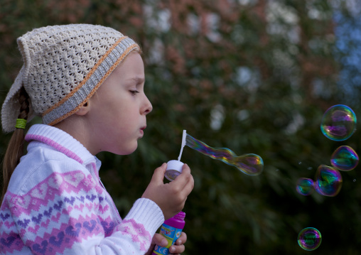 Alina, Ethnic Russian Girl Blowing Bubbles In Astana Park, Kazakhstan