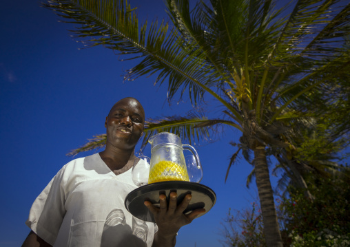 Waiter with fruit juice at forodhani house, Lamu county, Shela, Kenya