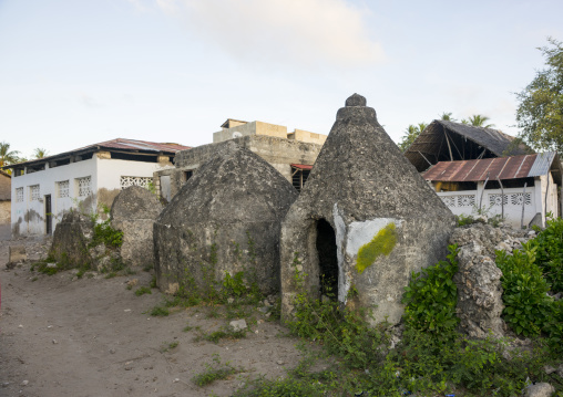 Old muslim graves in front of a modern building, Lamu county, Matondoni, Kenya
