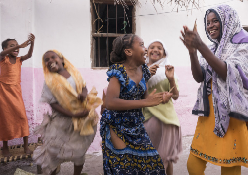 Girls dancing and singing in a courtyard, Lamu county, Matondoni, Kenya