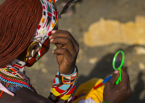 Rendille tribesman applying make up, Turkana lake, Loiyangalani, Kenya