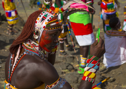 Portrait of rendille warrior applying make up, Turkana lake, Loiyangalani, Kenya