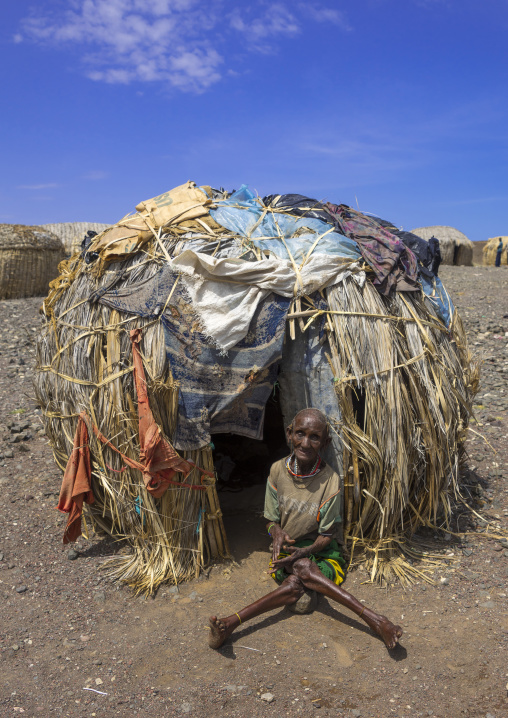 El molo handicapped tribeswoman in front of her hut, Turkana lake, Loiyangalani, Kenya