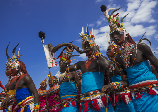 Rendille tribesmen blowing in a horn, Turkana lake, Loiyangalani, Kenya