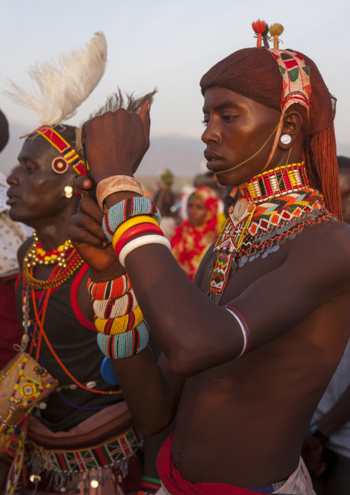 Portrait of rendille warrior taking pictures with his mobile phone, Turkana lake, Loiyangalani, Kenya
